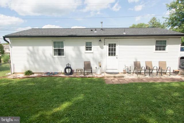 a white house that has a tree in front of it