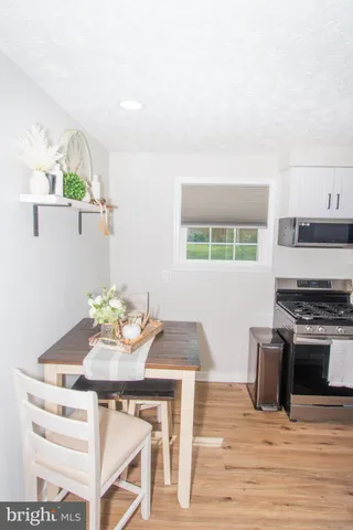 a kitchen with a table and chairs in it