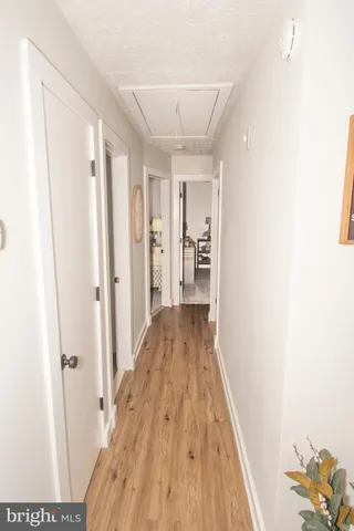 a view of a room with wooden floor