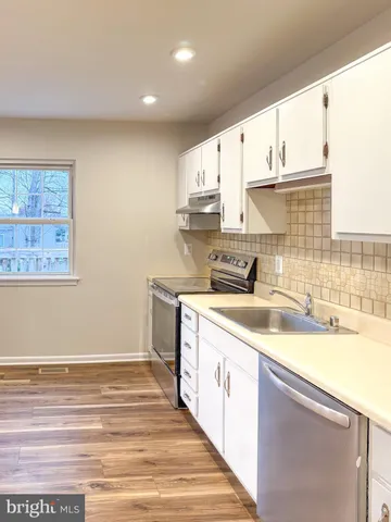 a kitchen with stainless steel appliances granite countertop a sink and cabinets