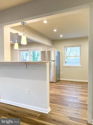 a view of a room with wooden floor and windows