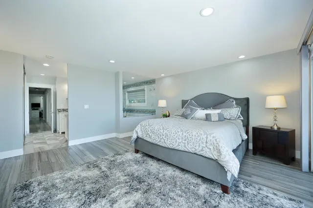 a bedroom with a bed and a mirror