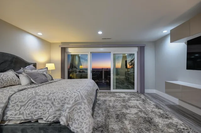 a bed room with a bed and a television