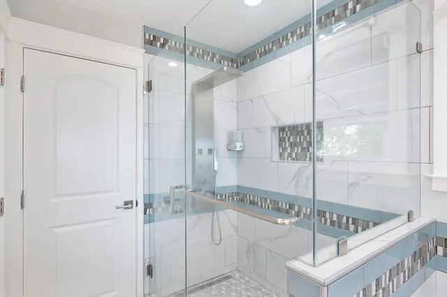 a bathroom with a shower and a glass door shower