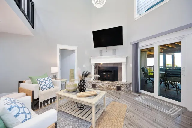a living room with furniture a fireplace and a flat screen tv