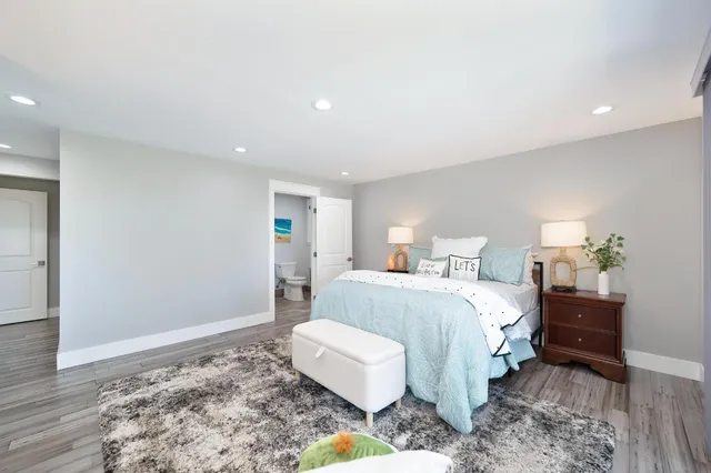 a spacious bedroom with a bed and a window