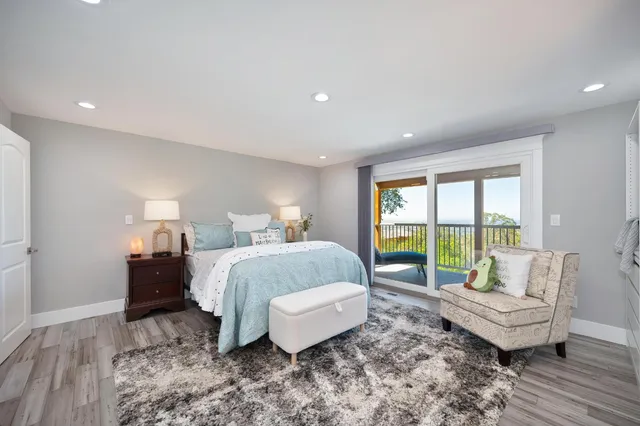 a spacious bedroom with a bed and large windows