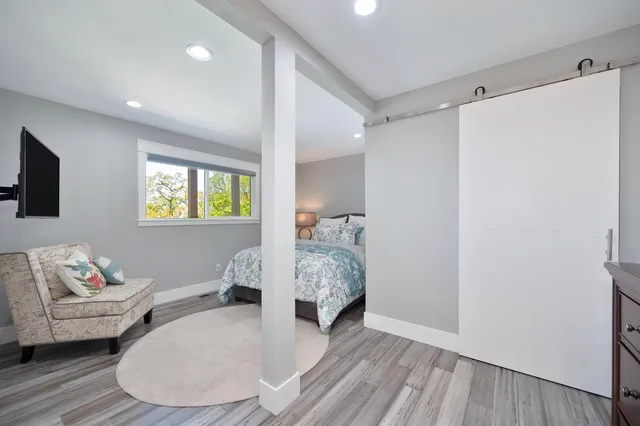 a living room with furniture and a wooden floor