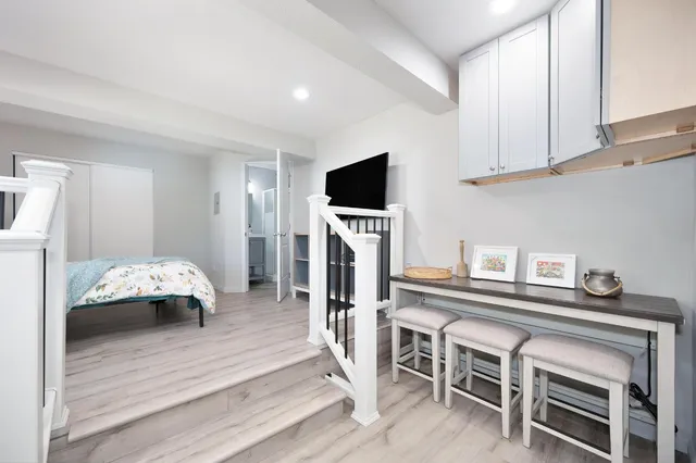 a bedroom with furniture and a flat screen tv