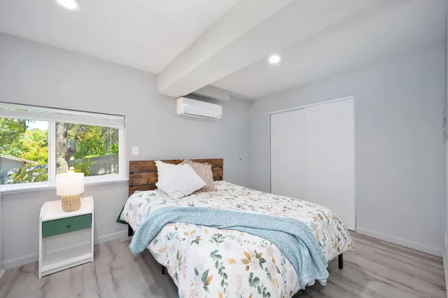 a bed sitting in a bedroom next to a window