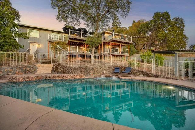 a aerial view of a house with a yard table and chairs