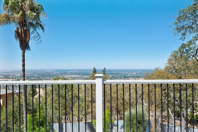 a view of a balcony with wooden fence