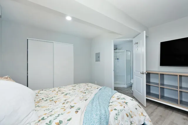 a bedroom with a bed and a flat screen tv