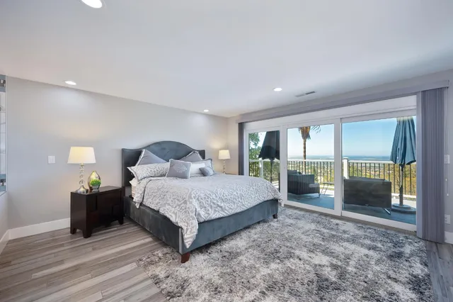 a spacious bedroom with a bed and large window