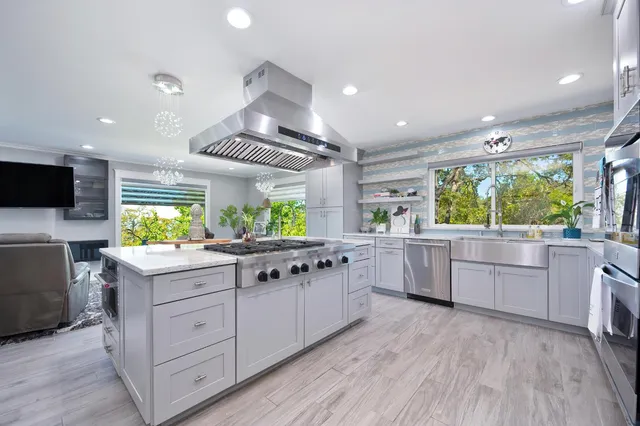 a kitchen with stainless steel appliances kitchen island a large island in the center