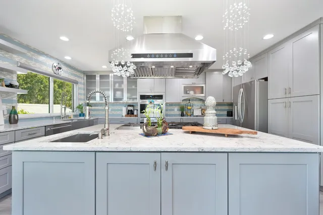 a kitchen with sink and refrigerator