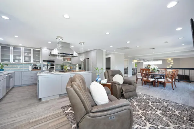 a living room with furniture a dining table and kitchen view
