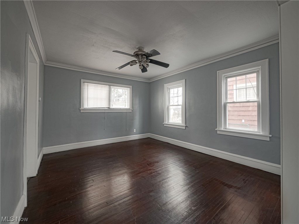 1007 Rushleigh Road Cleveland Heights, OH 44121 - Photo 5 of 22 room featuring dark wood-type flooring, ceiling fan, and ornamental molding