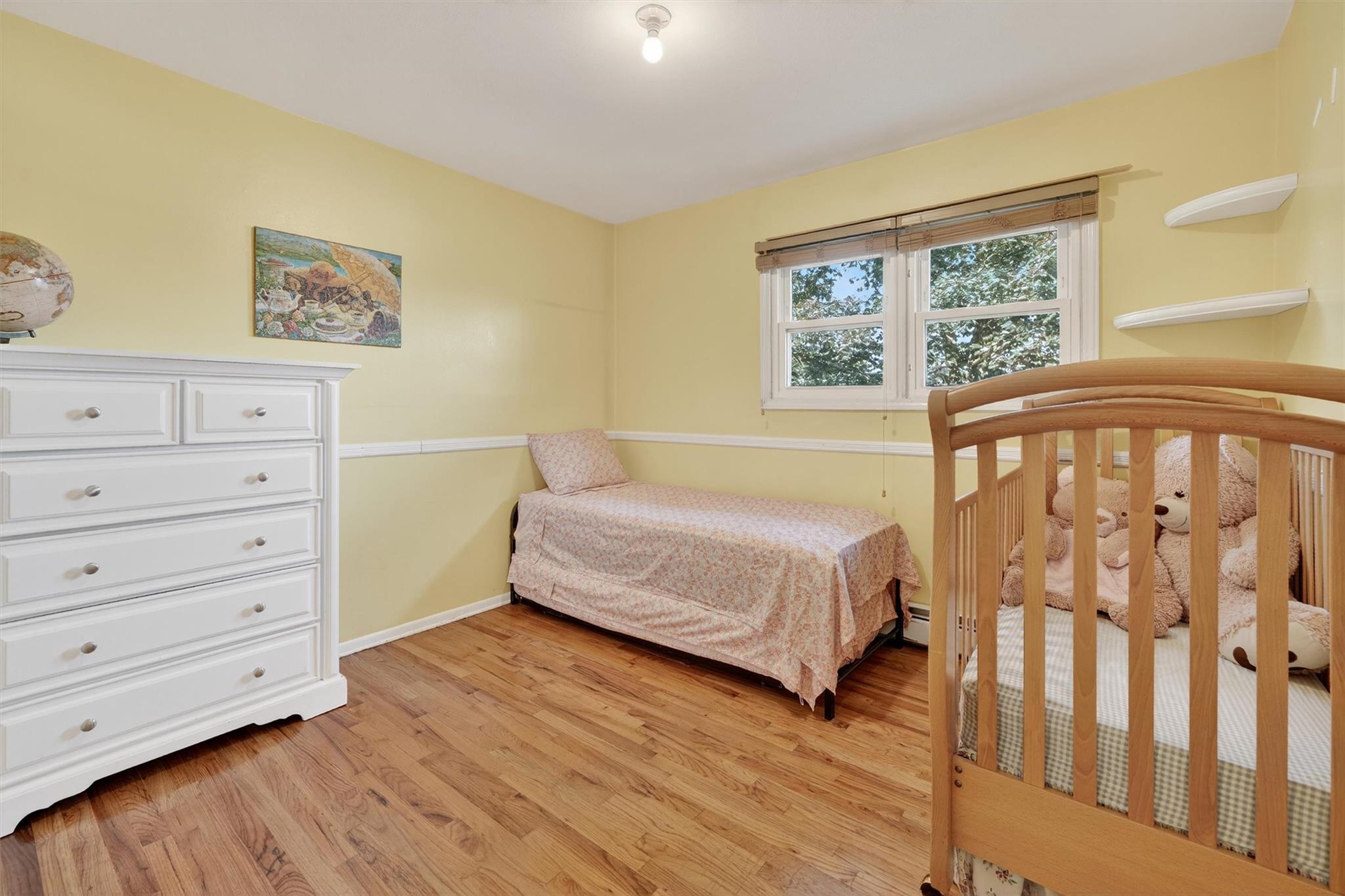 15 Dr Frank Road Spring Valley, NY 10977 - Photo 21 of 50 Bedroom featuring light wood-style flooring and a baseboard heating unit