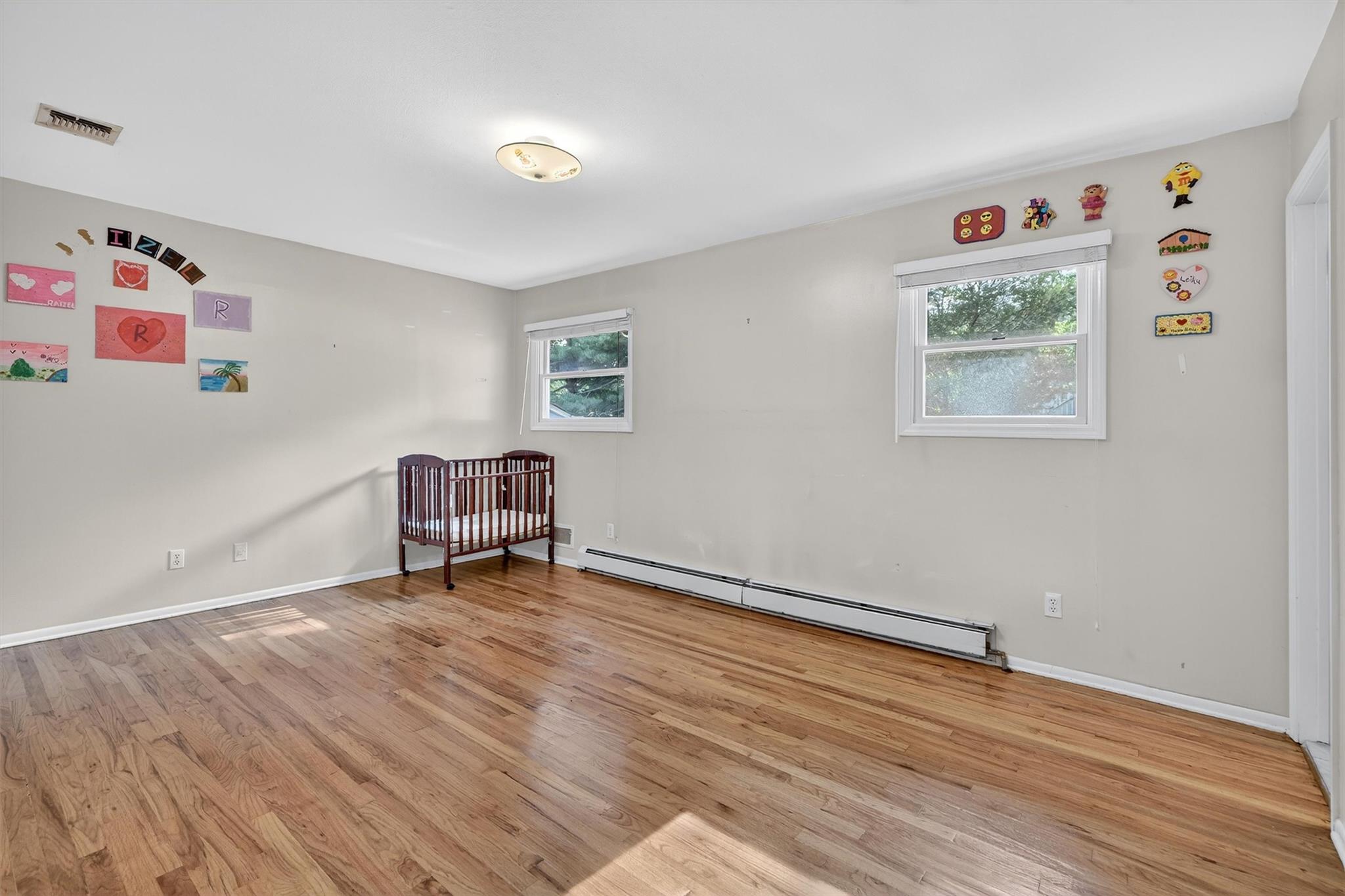 15 Dr Frank Road Spring Valley, NY 10977 - Photo 24 of 50 Unfurnished room featuring a baseboard heating unit and light wood-style floors