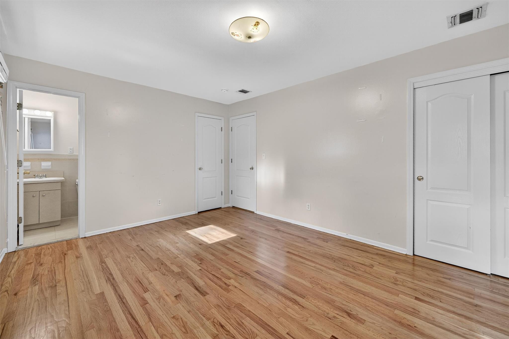 15 Dr Frank Road Spring Valley, NY 10977 - Photo 26 of 50 Unfurnished bedroom featuring light wood finished floors and ensuite bathroom