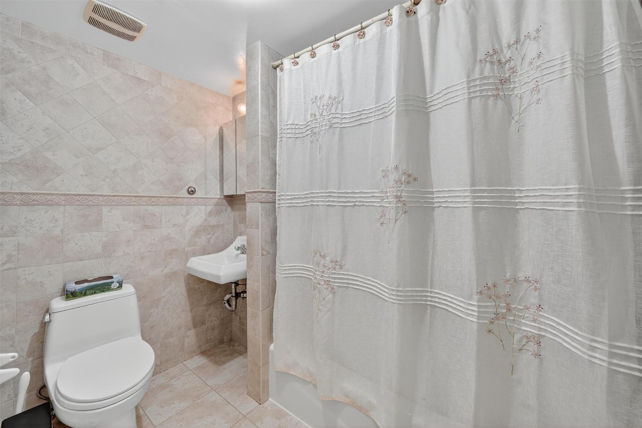15 Dr Frank Road Spring Valley, NY 10977 - Photo 29 of 50 Full bath featuring tile walls, shower / tub combo with curtain, and tile patterned floors