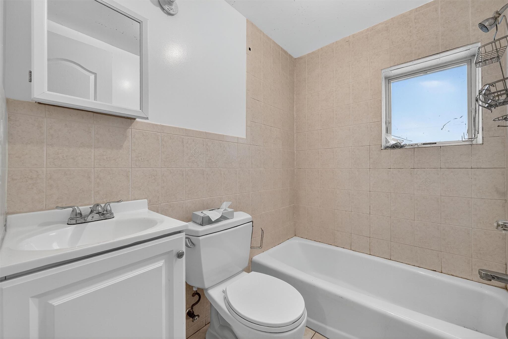 15 Dr Frank Road Spring Valley, NY 10977 - Photo 39 of 50 Full bathroom with tile walls, tub / shower combination, and vanity