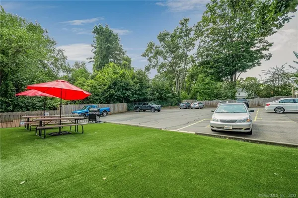a view of a backyard with swimming pool table and chairs