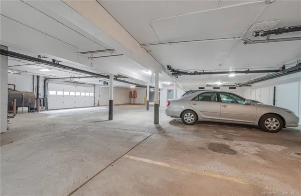 a view of parking garage with cars parked