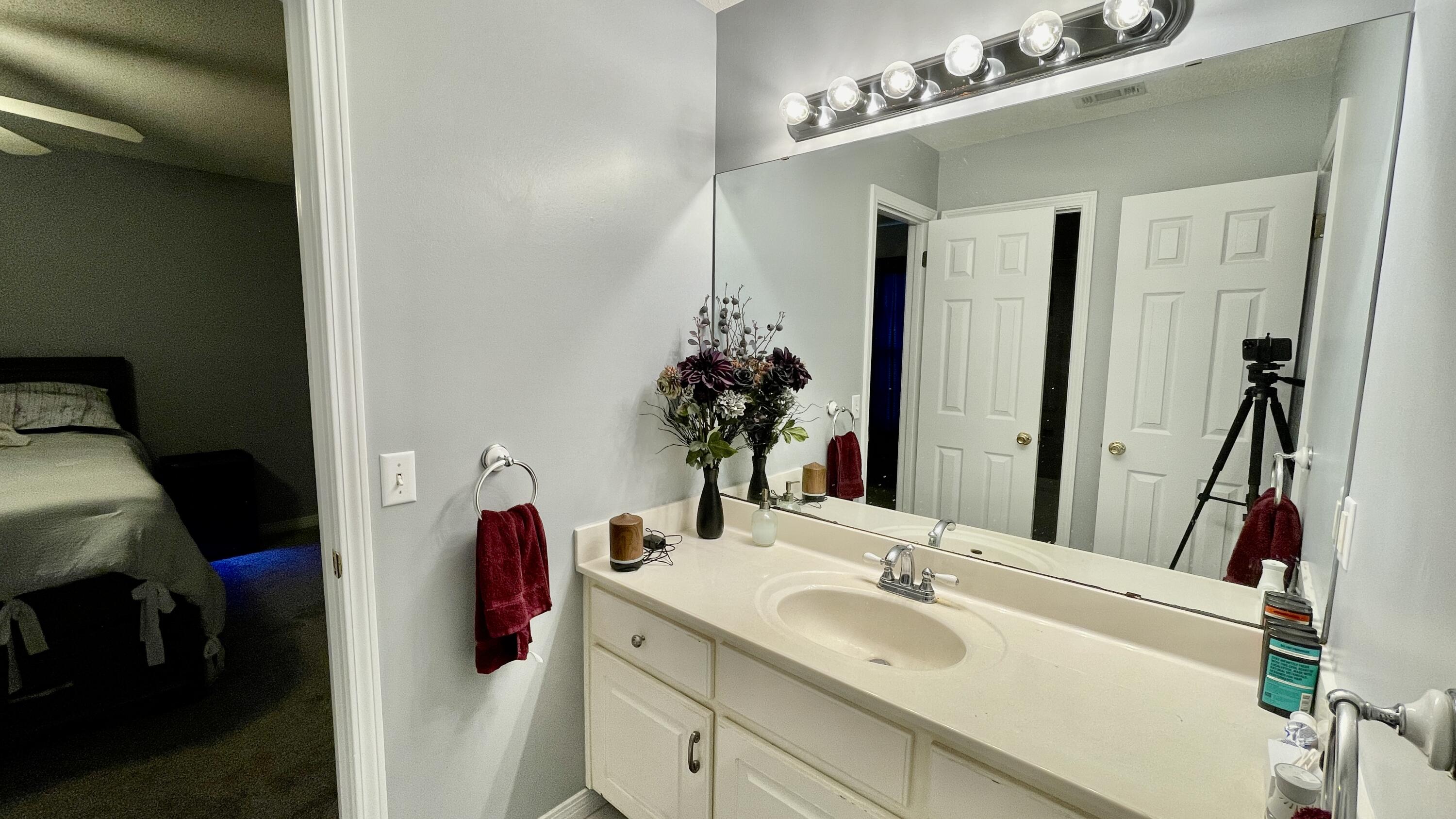 4467 Kingslynn Road Niceville, FL 32578 - Photo 12 of 28 a bathroom with a sink and a mirror