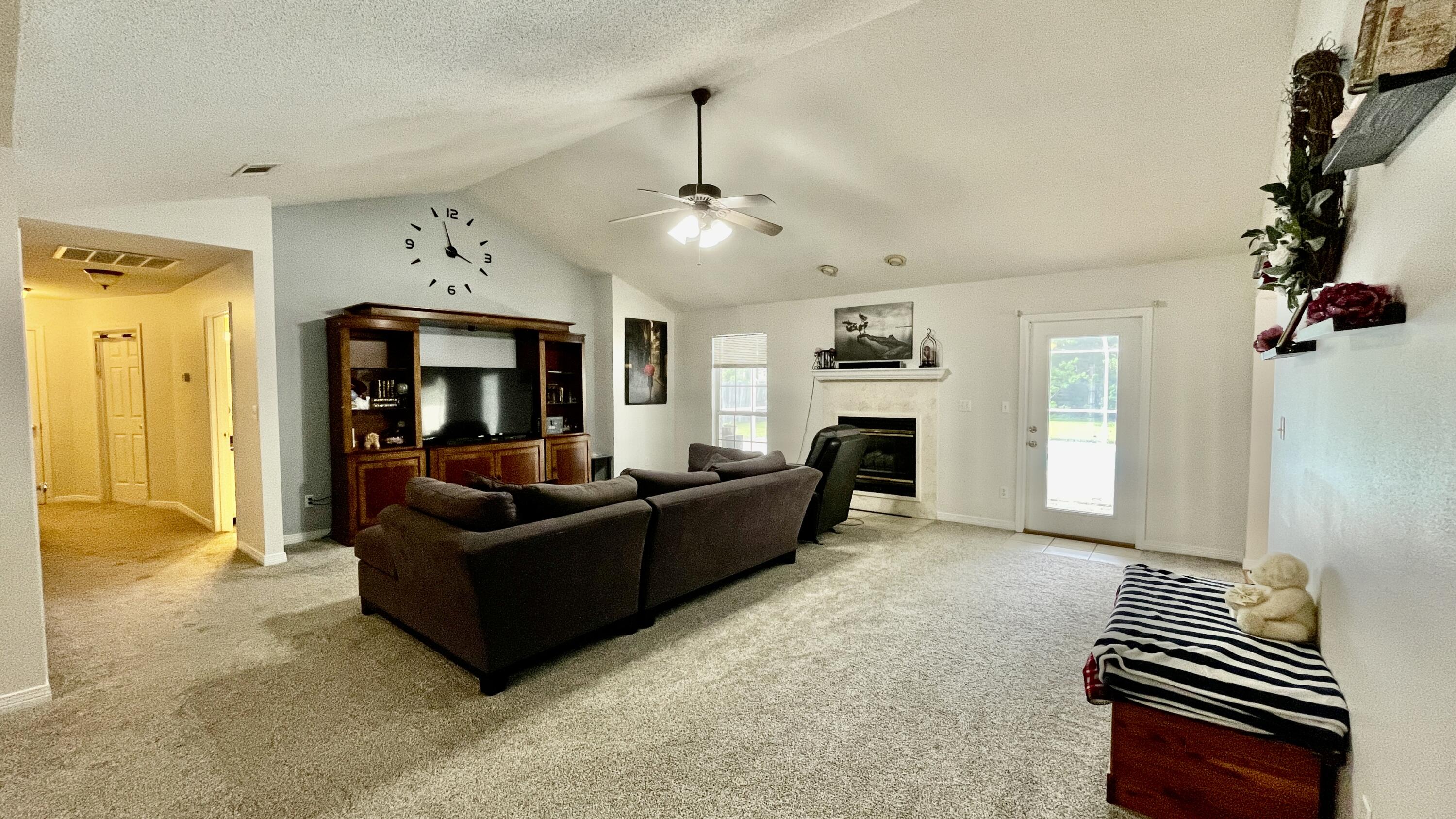 4467 Kingslynn Road Niceville, FL 32578 - Photo 16 of 28 a living room with furniture and a fireplace