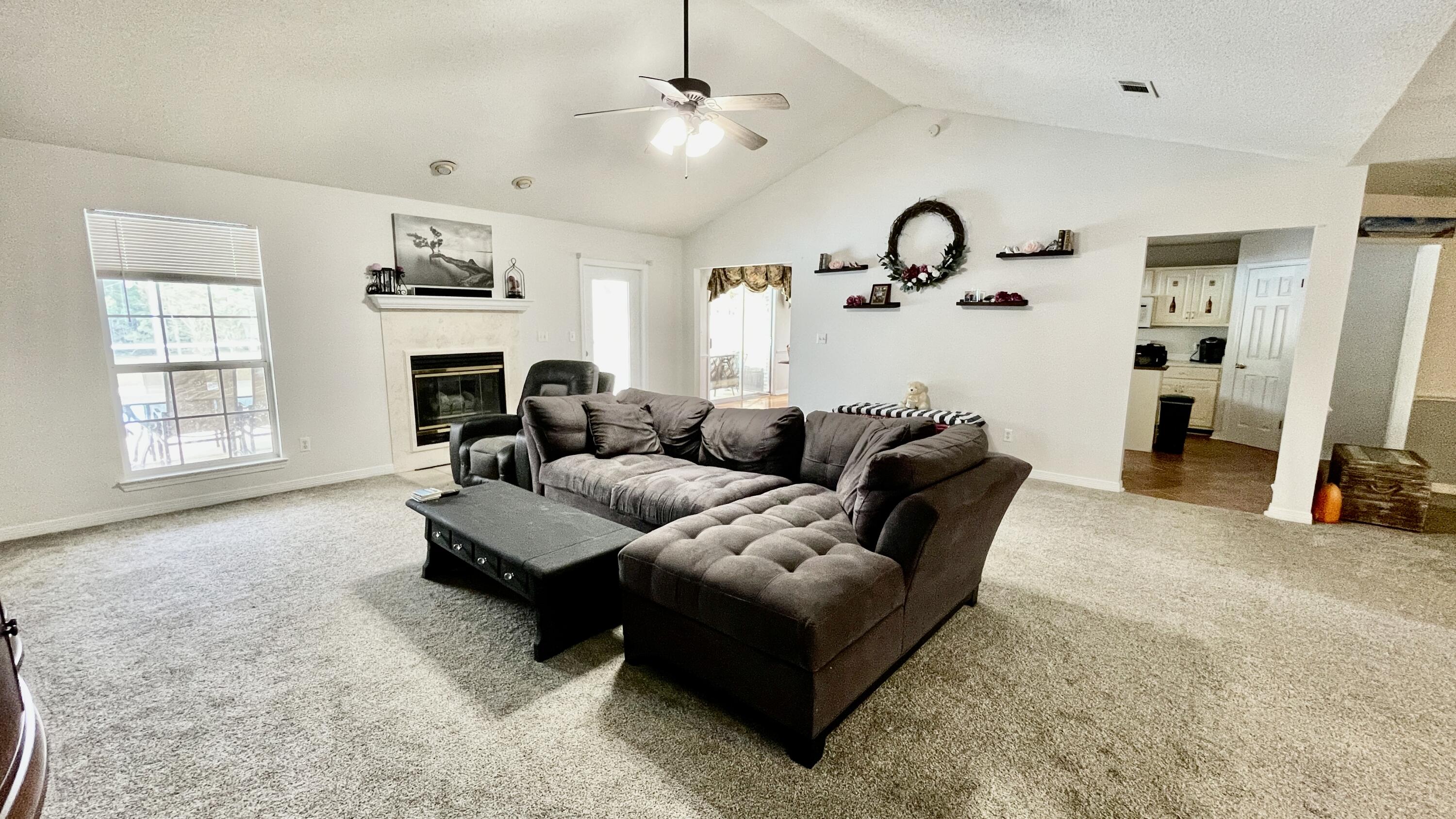 4467 Kingslynn Road Niceville, FL 32578 - Photo 17 of 28 a living room with furniture and a fireplace