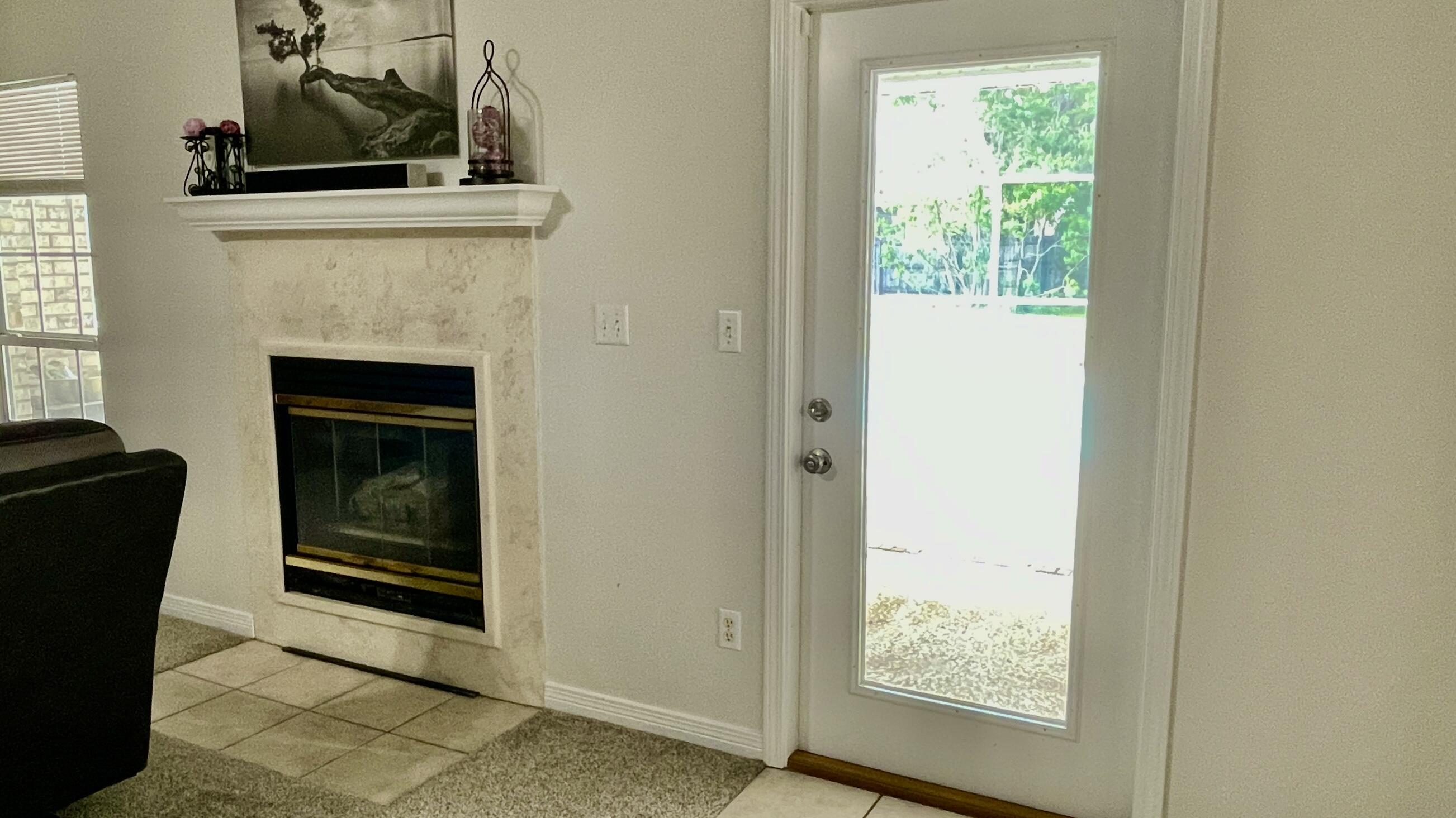 4467 Kingslynn Road Niceville, FL 32578 - Photo 19 of 28 a living room with a fireplace and a window