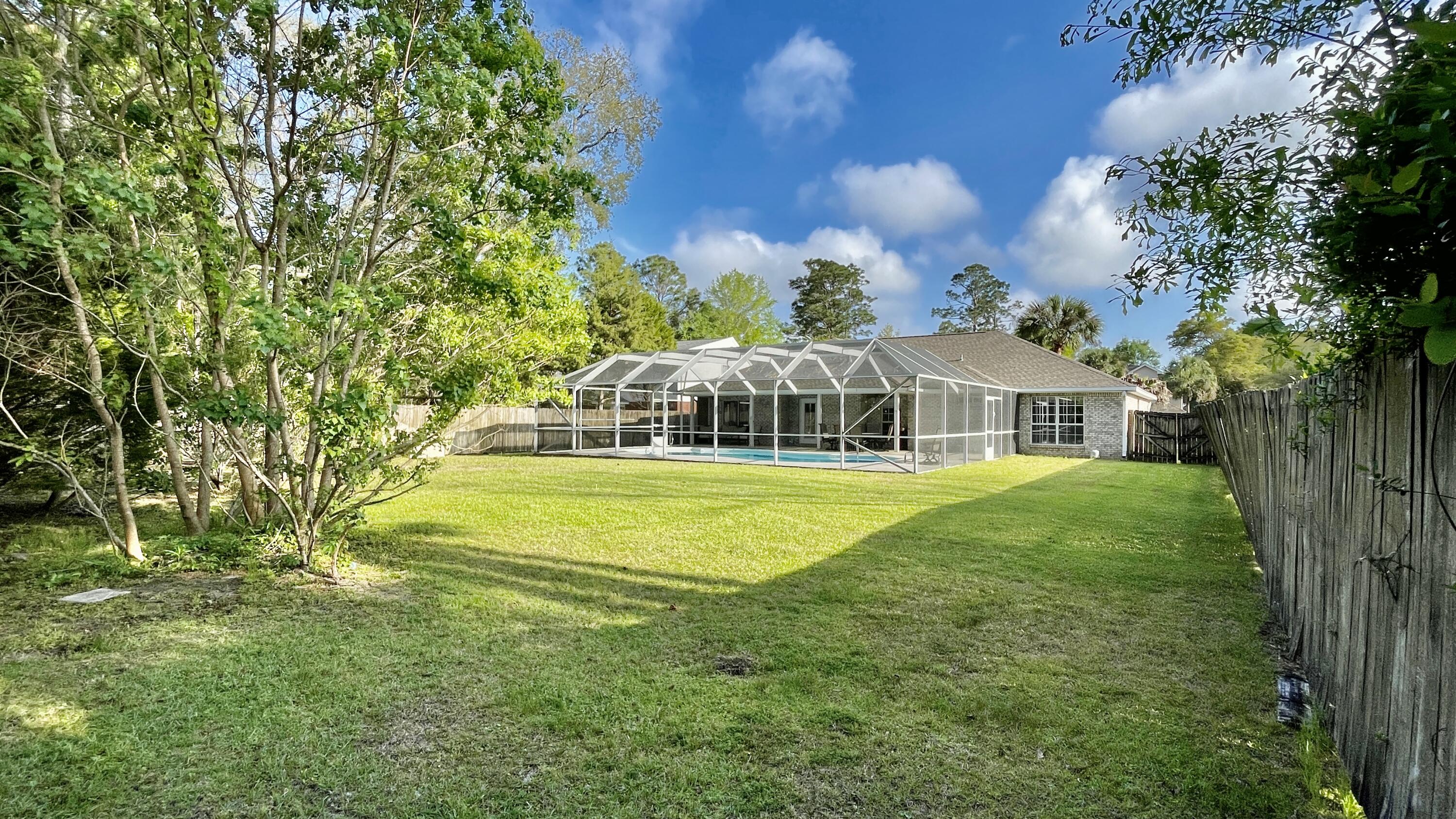 4467 Kingslynn Road Niceville, FL 32578 - Photo 26 of 28 a front view of a house with a big yard