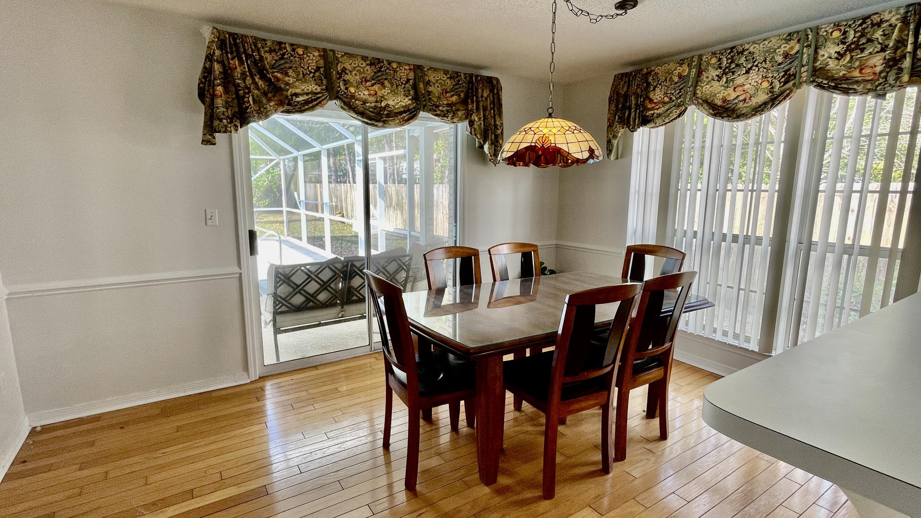 4467 Kingslynn Road Niceville, FL 32578 - Photo 7 of 28 a view of a dining room with furniture window and wooden floor