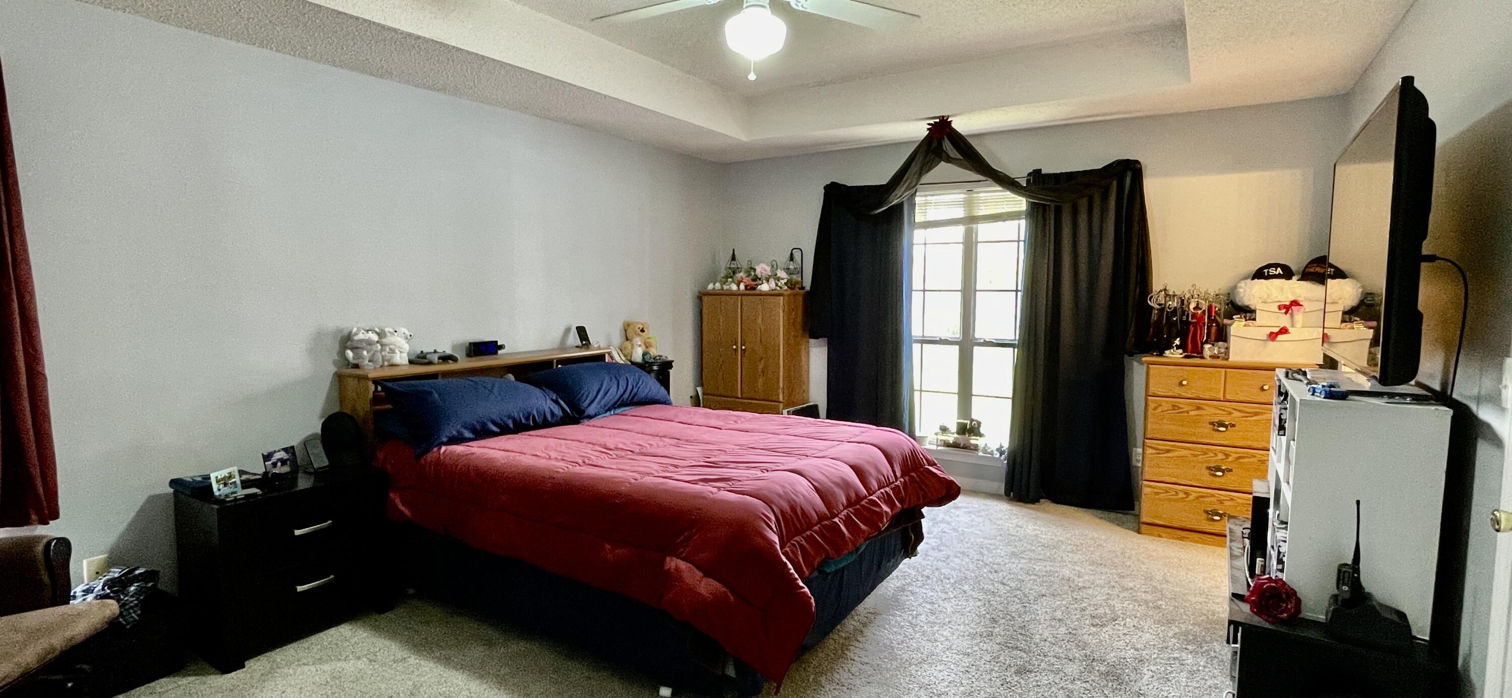 4467 Kingslynn Road Niceville, FL 32578 - Photo 9 of 28 a bedroom with a bed dresser and a flat tv screen