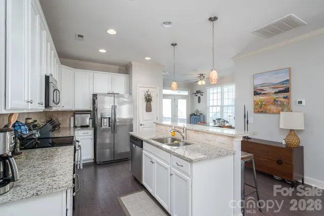 a kitchen with refrigerator a stove and a sink