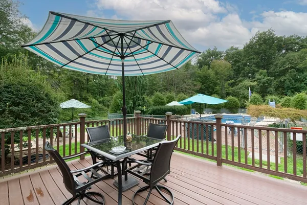 a view of a roof deck with furniture