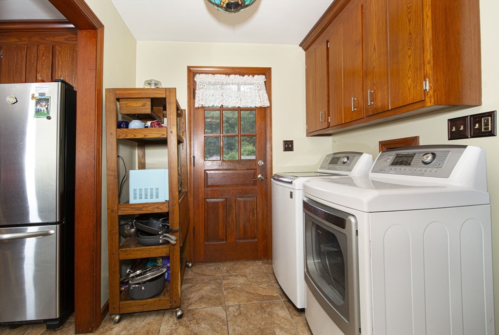 926 Old Turnpike Road Oakham, MA 01068 - Photo 19 of 42 a utility room with dryer washer and a fridge