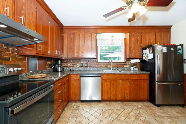 a view of kitchen with stainless steel appliances granite countertop cabinets and a sink