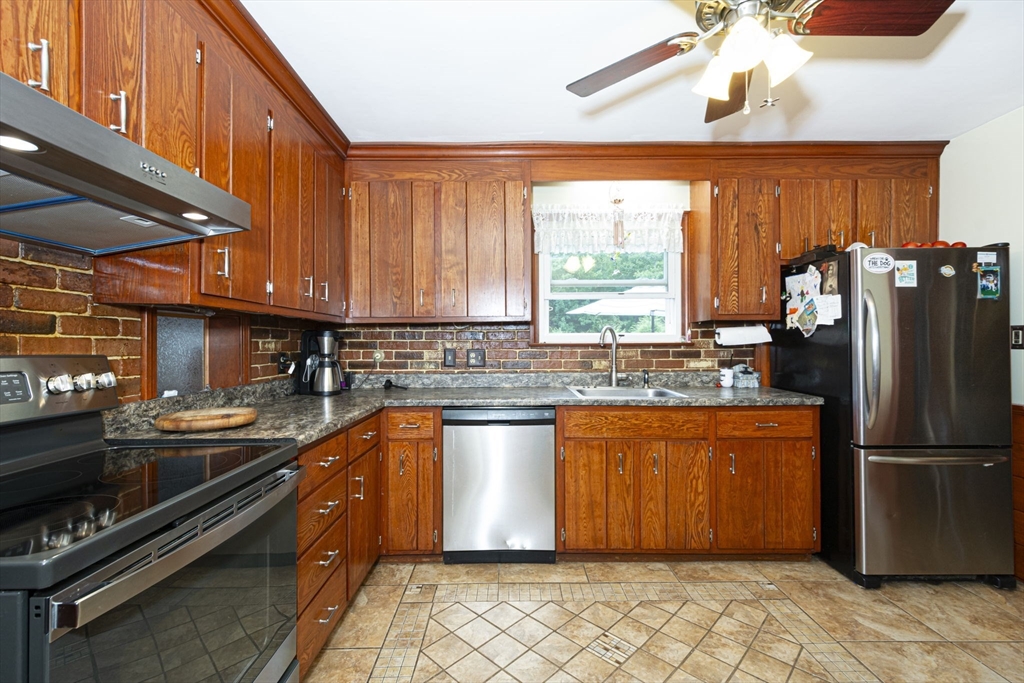 926 Old Turnpike Road Oakham, MA 01068 - Photo 20 of 42 a kitchen with stainless steel appliances granite countertop a refrigerator a sink dishwasher a stove and white countertops with wooden floor