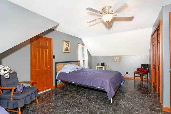 a bedroom with a bed and a chandelier