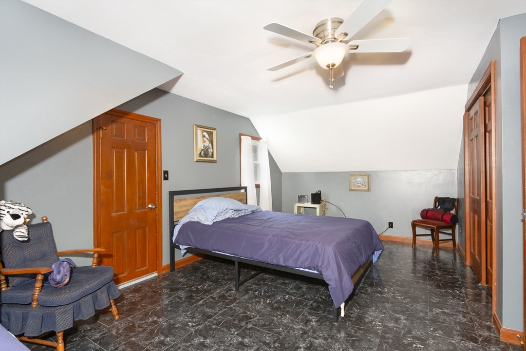 926 Old Turnpike Road Oakham, MA 01068 - Photo 26 of 42 a spacious bedroom with a bed and a chandelier