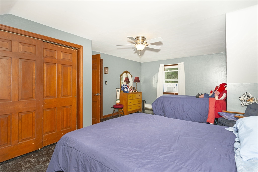 926 Old Turnpike Road Oakham, MA 01068 - Photo 27 of 42 a bedroom with a bed and a chandelier