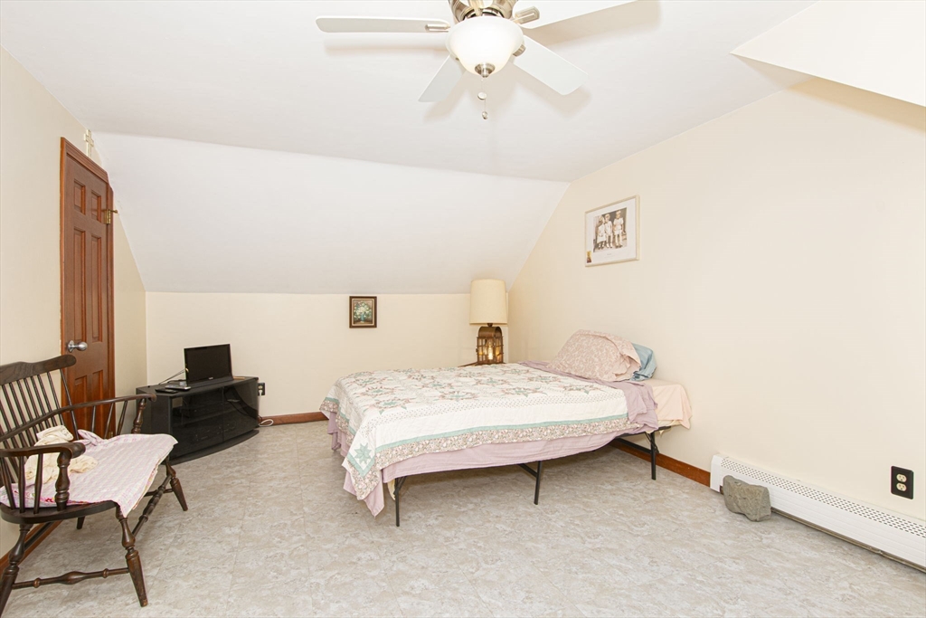 926 Old Turnpike Road Oakham, MA 01068 - Photo 29 of 42 a bedroom with a bed and a chandelier