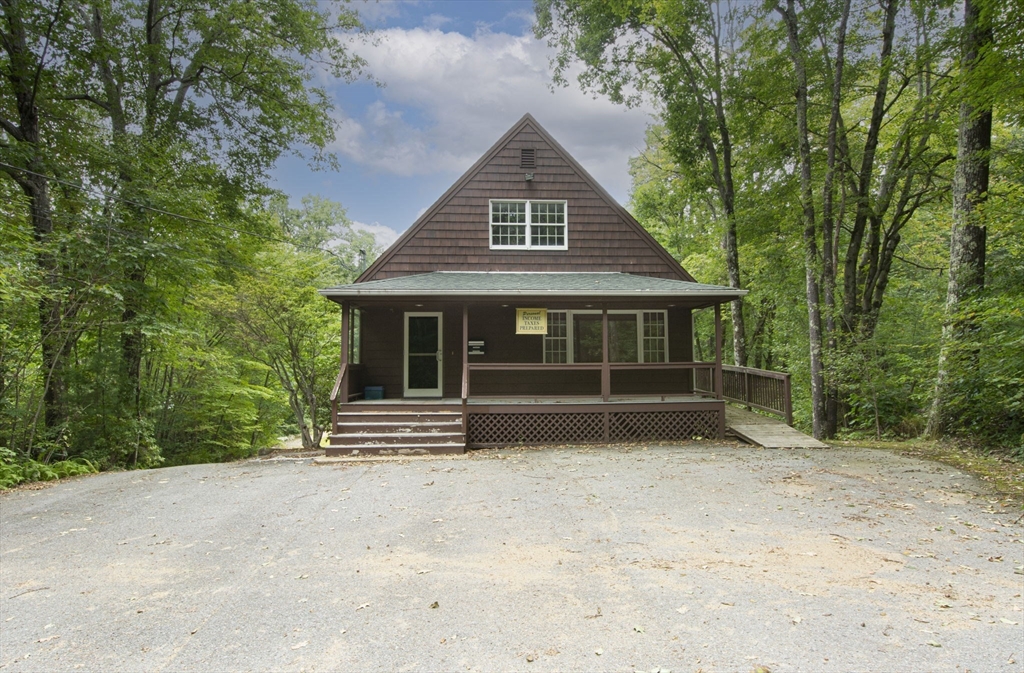 926 Old Turnpike Road Oakham, MA 01068 - Photo 3 of 42 a front view of a house with a garden