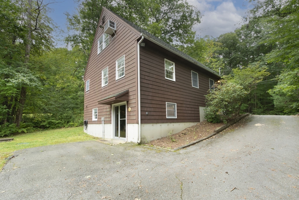 926 Old Turnpike Road Oakham, MA 01068 - Photo 34 of 42 a view of a house with backyard and trees