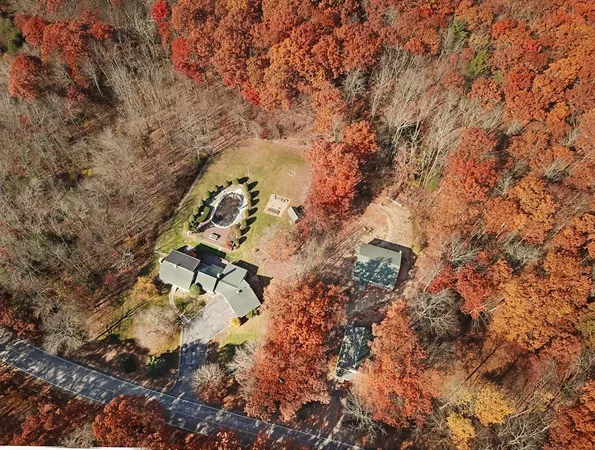 an aerial view of a house with a yard