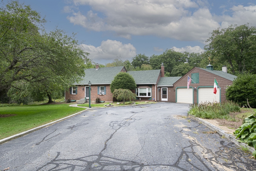 926 Old Turnpike Road Oakham, MA 01068 - Photo 6 of 42 a front view of a house with a yard and garage