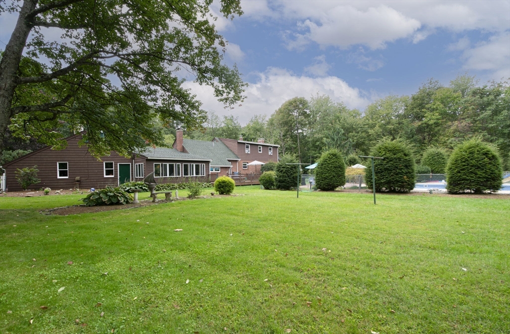 926 Old Turnpike Road Oakham, MA 01068 - Photo 8 of 42 a front view of a house with a yard and trees